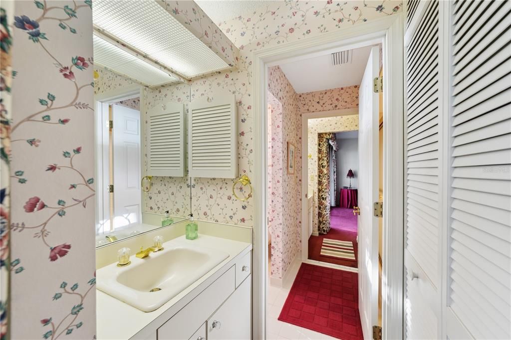 Jack and Jill bathroom with tub and shower, and twin vanities.