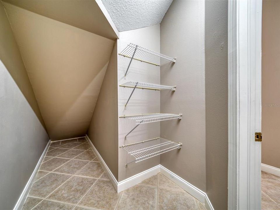 Storage was maximized with this Large Storage Closet Under the Stairs for Pantry off of the Kitchen