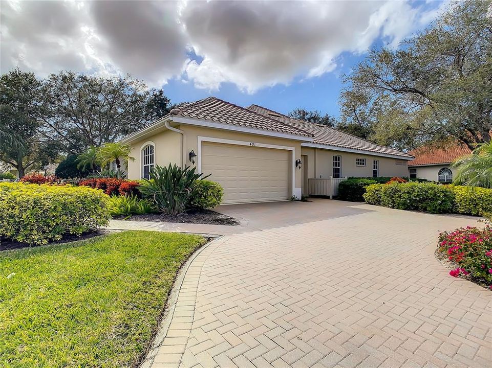 Beautiful paved drive with walk leading to front of home.