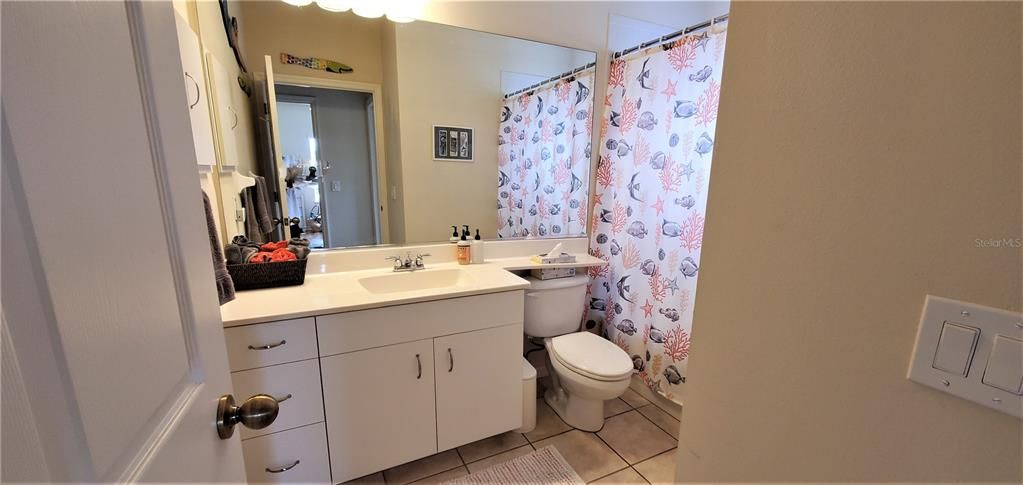Guest Bathroom with shower over tub.