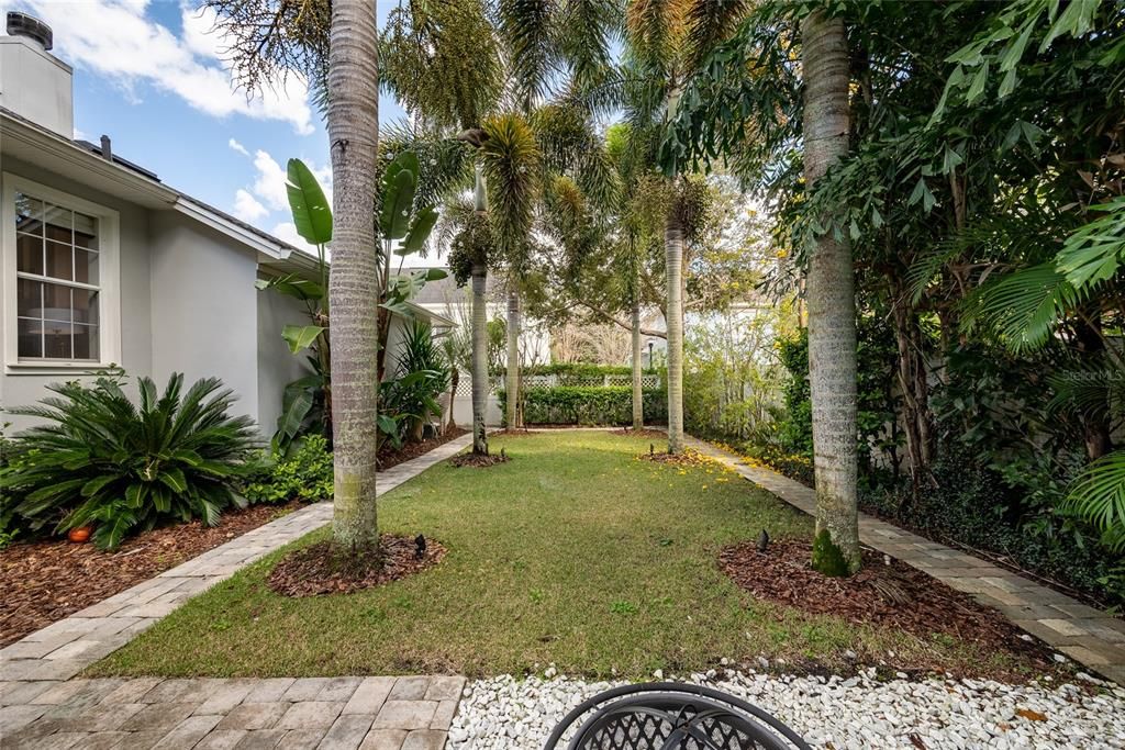 Florida Living with mature tropical  ladscping and paver courtyard, yes you can add a pool.