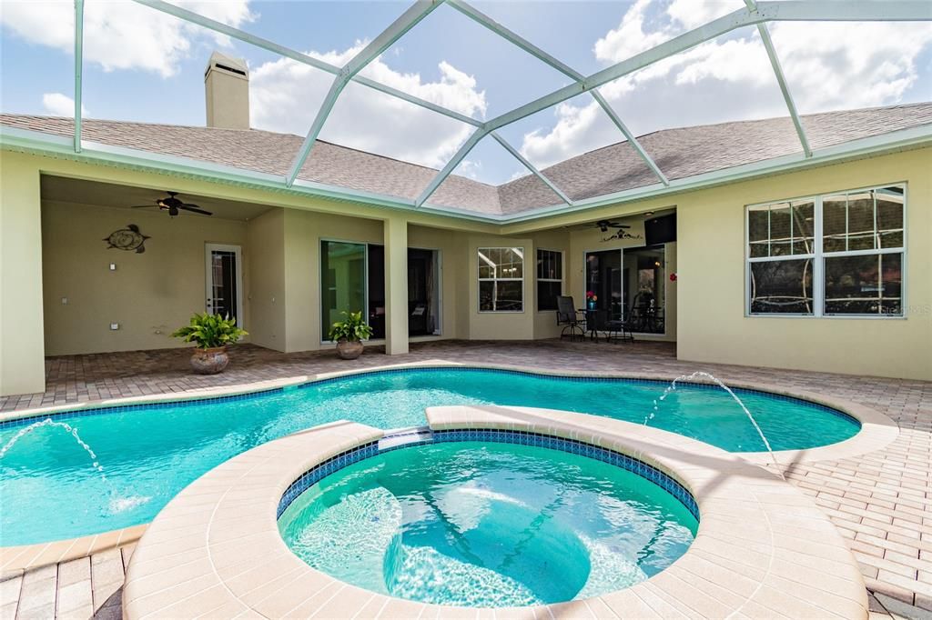 Your gas heated pool and jacuzzi features water fountain features and a cascading waterfall.
