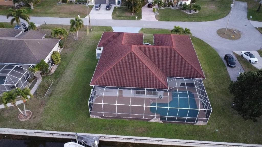 Aerial View showing part of dock, seawall, pool area & spacious lot