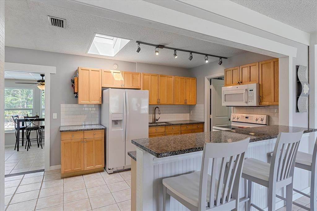 Kitchen with granite and tile backsplash