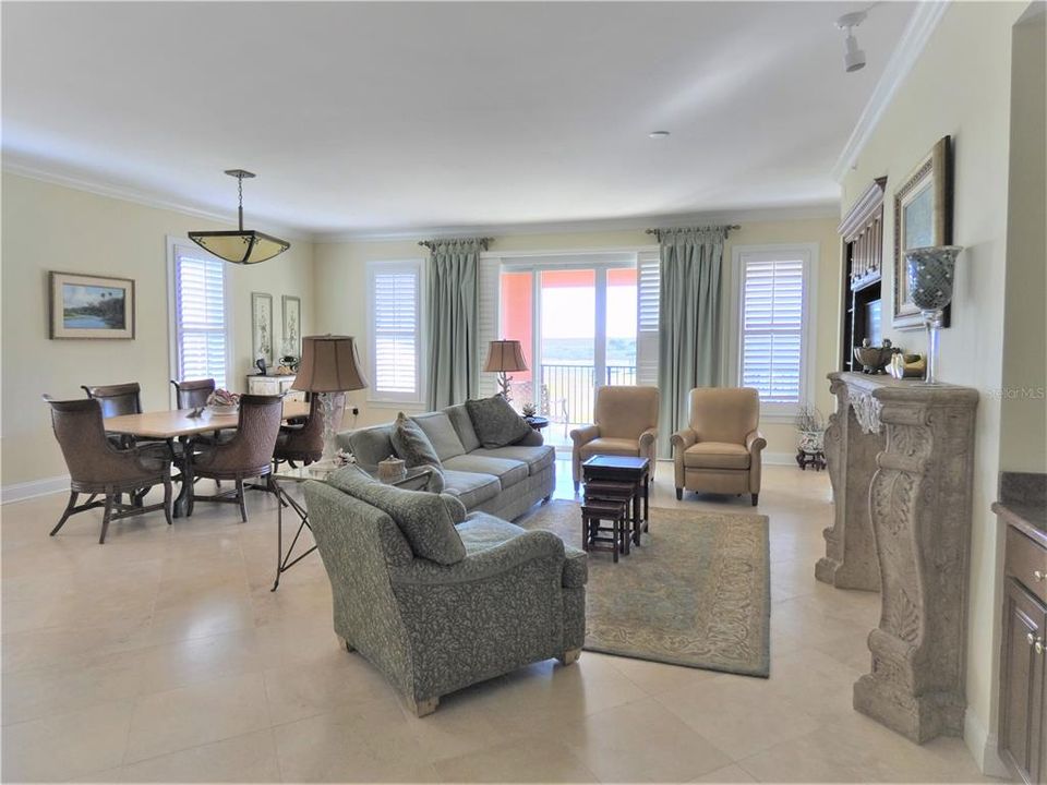 LARGE GREAT ROOM/DINING AREA WITH GLEAMING SATURNIA TRAVERTINE FLOORS