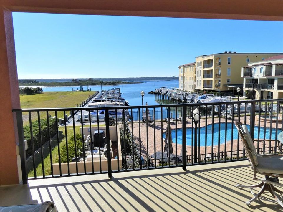 VIEW FROM BALCONY OVERLOOKS INTERCOASTAL, POOL AND MARINA