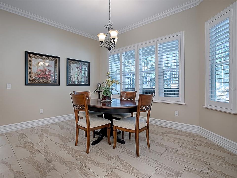 THE BRIGHT AND SPACIOUS CASUAL DINING AREA JUST OFF THE KITCHEN, PLANTATION SHUTTERS THROUGHOUT THIS HOME