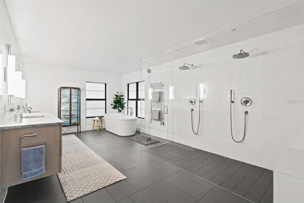Owners primary bathroom with super large walk in shower with two wall shower heads