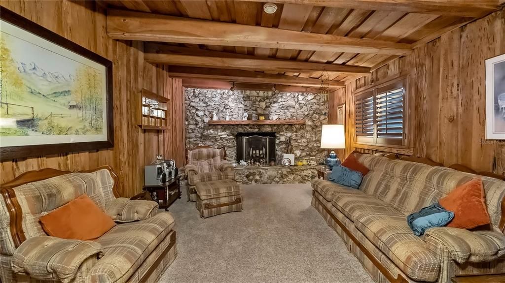Pecky Cypress Walls with Large Stone Wood-burning Fireplace