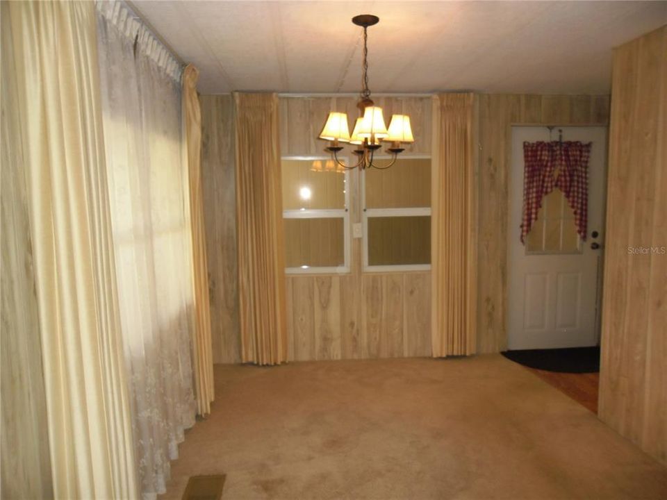 dining area adjacent to kitchen and entry door