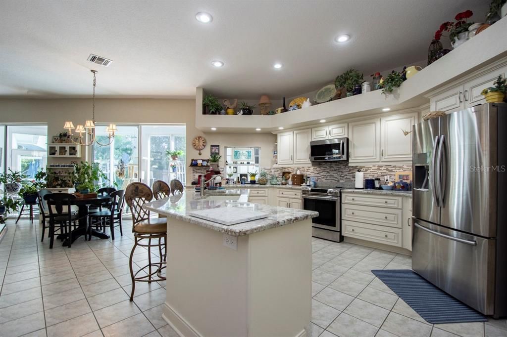 Large open kitchen with granite counters and slow close cabinets.