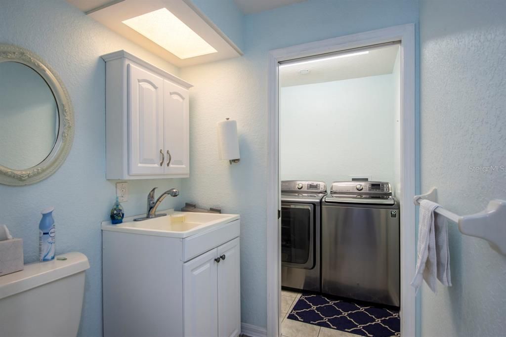Laundry Room with half bath and utility sink.