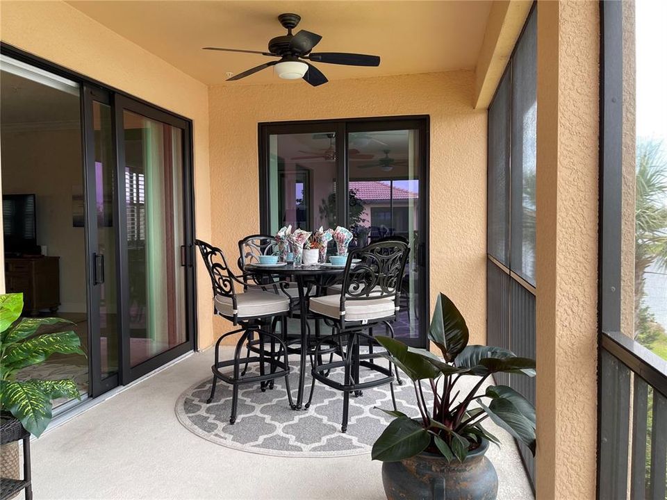 The lanai is beautifully decorated for leisure and entertaining.  The dining area looks over the water and the 12th green. The pub table and 4 chairs are heavy duty to withstand winds.