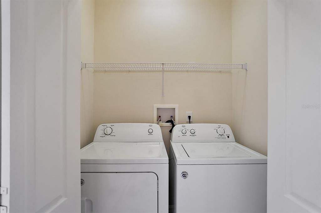 Interior laundry facilities located in hallway to bedrooms 2 & 3.  Washer and dryer remain