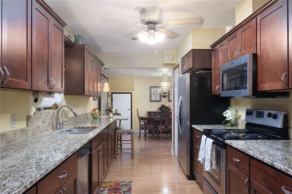 Updated kitchen with beautiful wood cabinets and granite