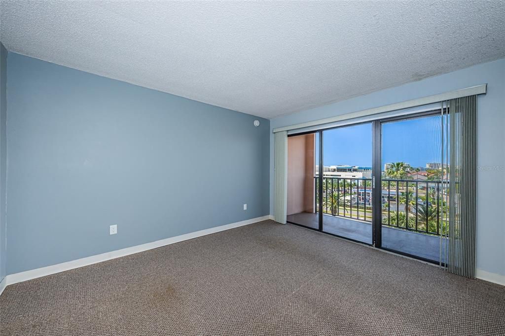 Spacious bedroom with balcony access.