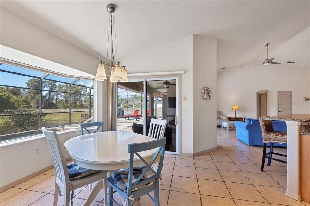 large dinette adjoins kitchen with outdoor vista