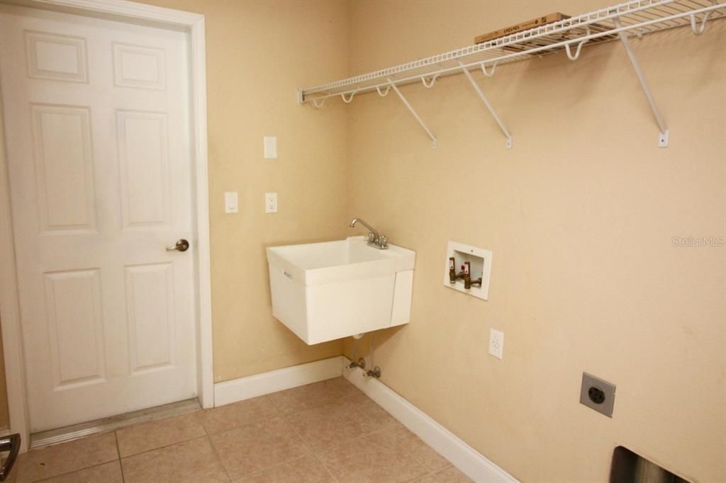 LAUNDRY ROOM WITH ENTRY TO GARAGE