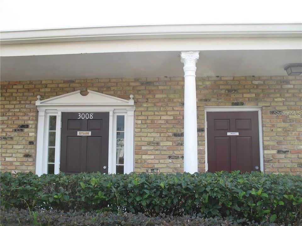 Main entrance on left and separate office entry on right.