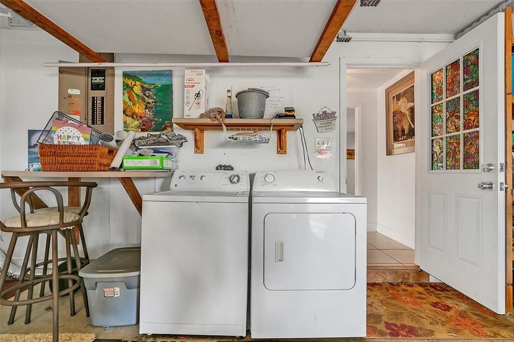 Over-sized 2 car garage with laundry area and to the right is hidden enclosed storage room.