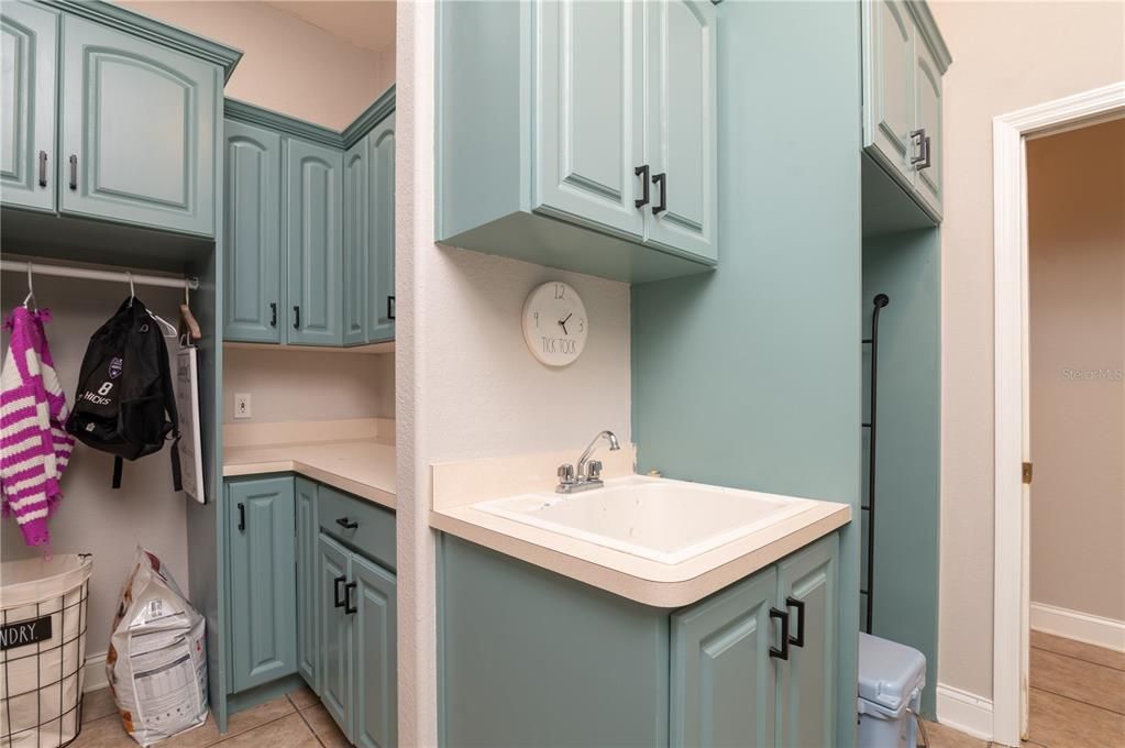 Spacious laundry room with cabinet