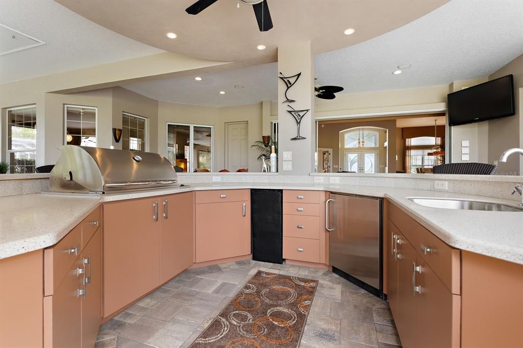 Summer kitchen with built in grill, wine refrigerator & sink