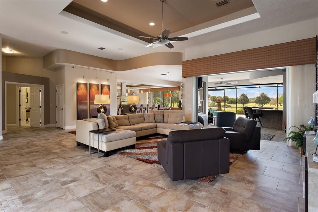 Living area with stackable sliders to summer kitchen