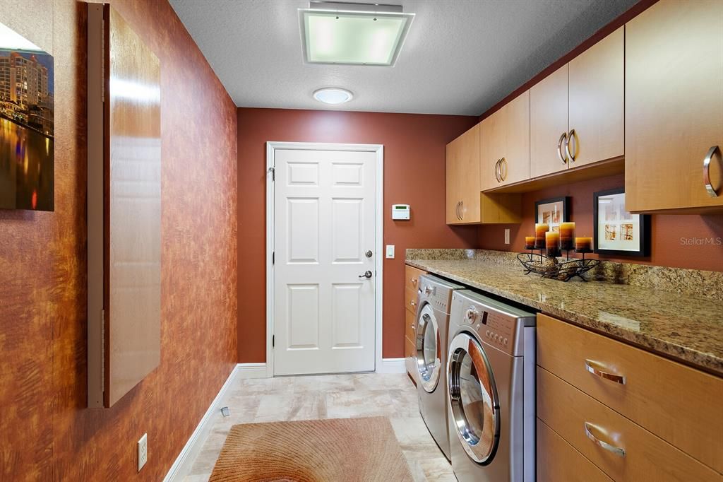 Inside laundry room with extra cabinet & counter space