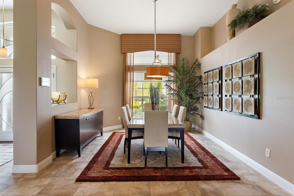 Dining area with upgraded light fixture & high ceiling