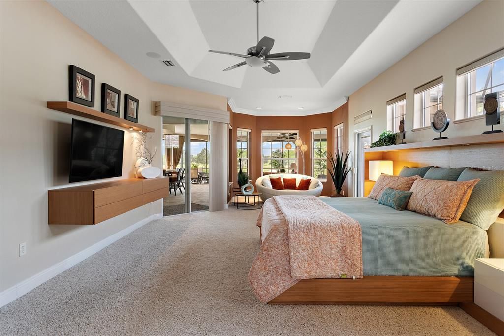 Master bedroom with tray ceiling and access to outdoor living