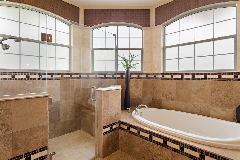 En suite with tiled Roman walk in shower & soaking tub