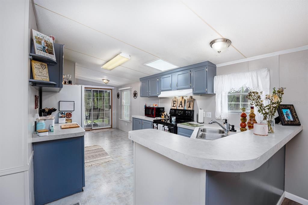 Kitchen area with breakfast bar and area for an eat-in kitchen off the side porch