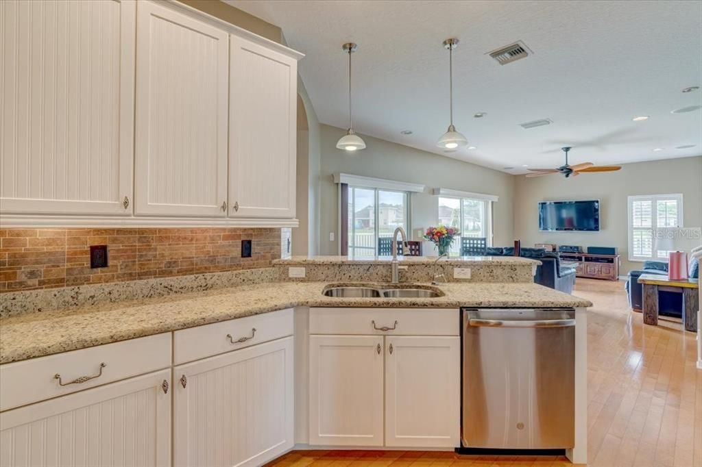 Enjoy the beautiful, open kitchen, with granite counters and wood cabinetry, overlooking the family room - perfect for entertaining!