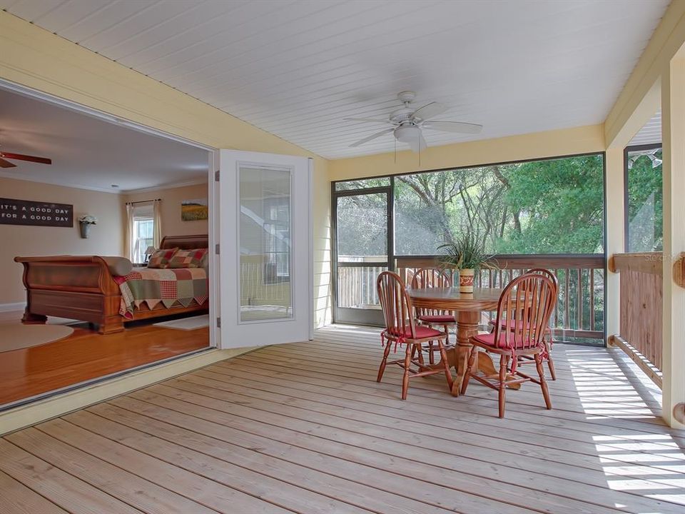 Enjoy cool evening breeze in master suite from the all screened in back porch