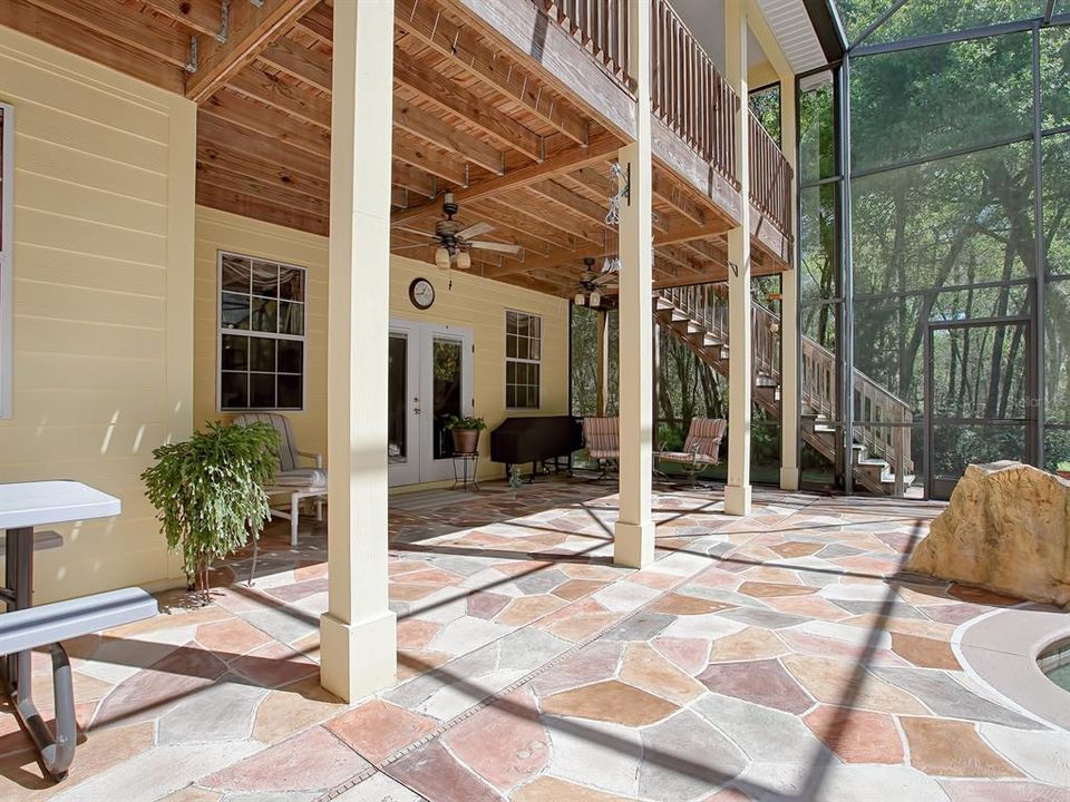 Custom made tile deck throughout poll and lower porch area includes outdoor kitchen