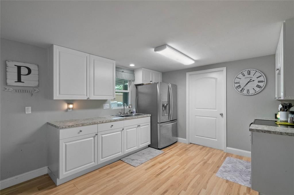 Kitchen with door to spacious laundry/pantry