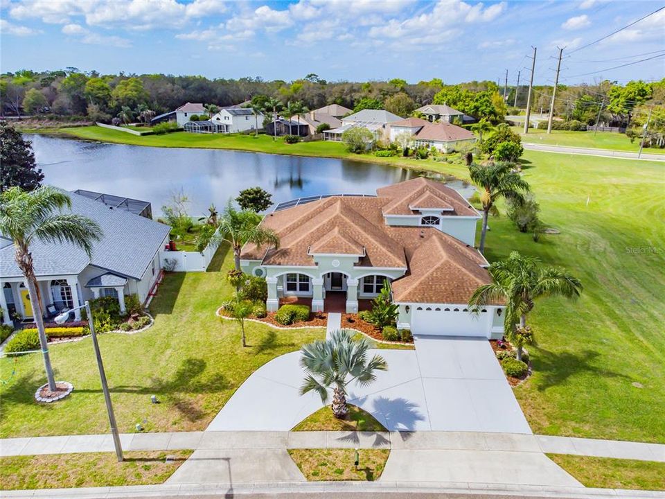 Front of home with screened pool and pond views!