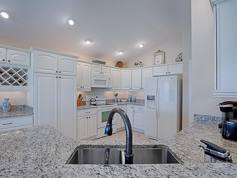 LOVELY GRANITE COUNTER TOPS WITH WHITE CABINETRY!