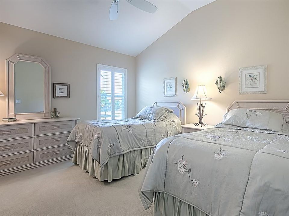 GUEST BEDROOM WITH VAULTED CEILINGS WITH CEILING FAN AND PLANTATION SHUTTERS!