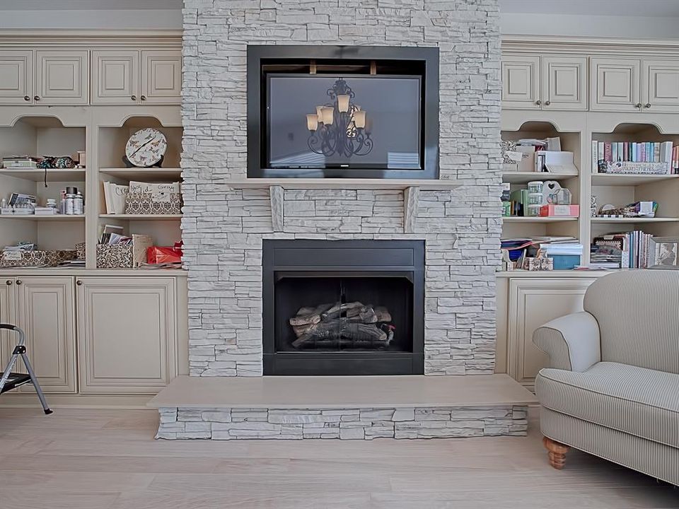 ANOTHER LOVELY STONE GAS FIREPLACE WITH OVERHEAD BUILT-IN TV!