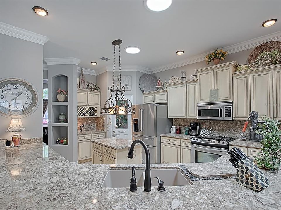 LOVELY QUARTZ COUNTER TOPS AND BACKSPLASH, WITH COMPOSITE SINK AND BRONZE HARDWARE!