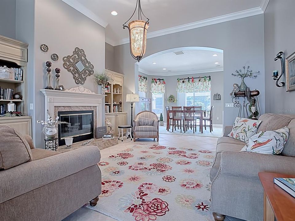 STRAIGHT AHEAD FROM THE FOYER, THE FORMAL LIVING ROOM WITH CUSTOM GAS FIREPLACE!  THIS ROOM HAS BEEN EXPANDED TO INCLUDE A "PIANO" ROOM OR A "CARD" ROOM - WHATEVER WORKS FOR YOUR LIFESTYLE!