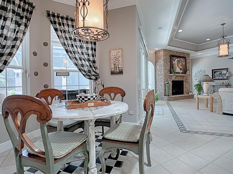 CASUAL DINING AREA HAS A GREAT VIEW OF THE POOL AND OPENS TO THE FAMILY ROOM!