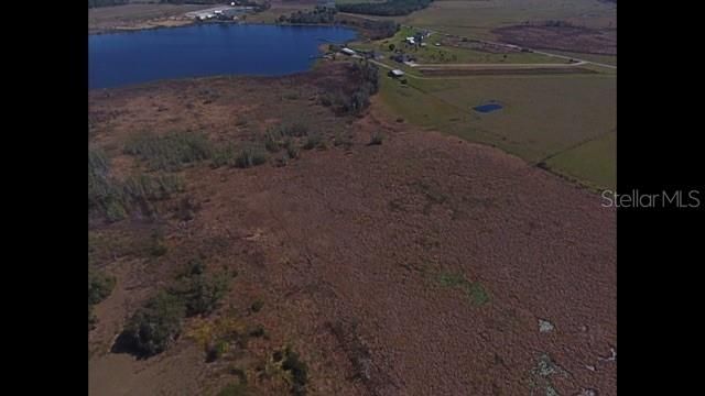Drone photo of larger area of property from turn in land line towards Lake Buffum
