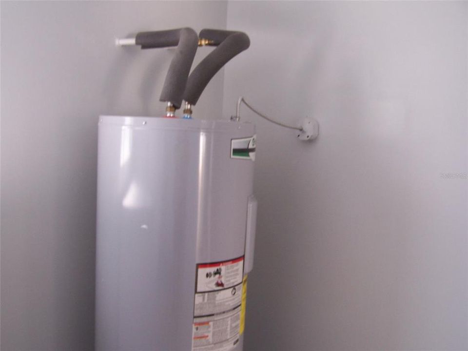 ELECTRIC HOT WATER HEATER IN LAUNDRY