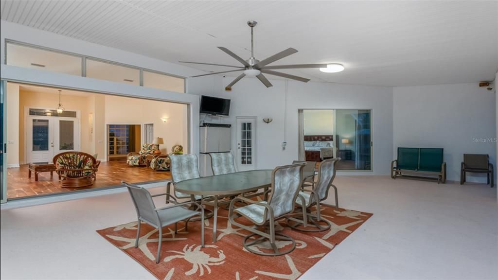 Covered Lanai with Bar Surrounded by Sliding Doors for Entertaining.