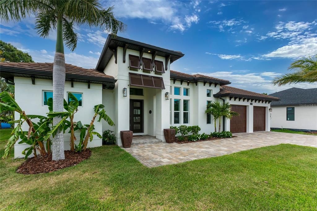 Corbels, bimini shutters, and upgraded outdoor lighting further accentuate this stunning home.