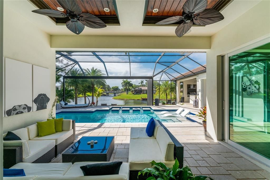 The generous oversized lanai is highlighted by double tray ceilings inset with stained Cypress and custom crown molding.