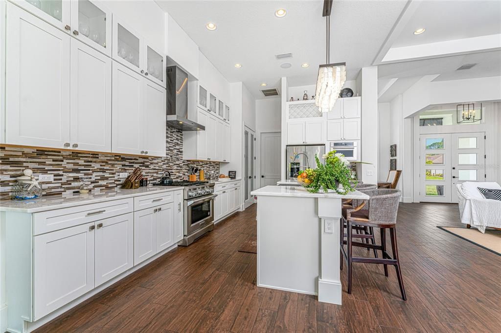The resident chef will appreciate the well-appointed kitchen, complete with professional grade Kitchen Aid appliances, including a 6-burner gas range with a convection oven and a convenient pot filler faucet.