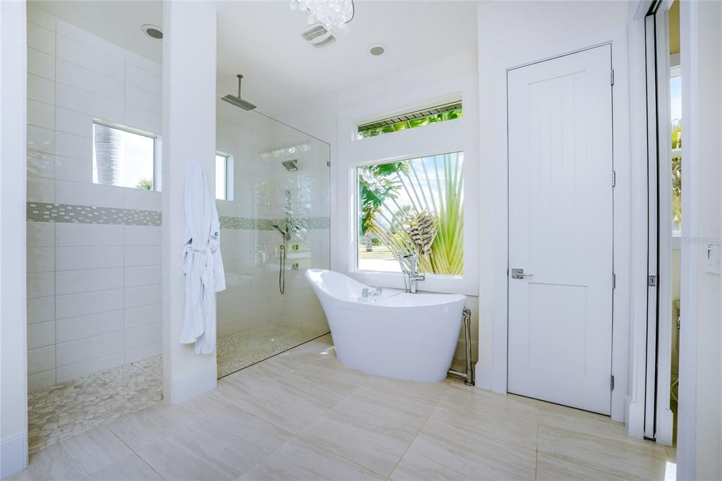 An invigorating shower, or a relaxing soak in the tub--the choice is yours. Upgraded designer wall tile, listellos, and oversized porcelain tile add dimension to this soothing space.
